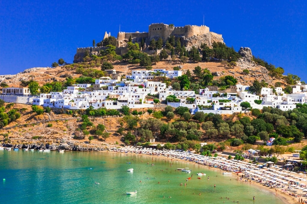 Rhodes, Greece. Lindos small whitewashed village and the Acropolis, scenery of Rhodos Island at Aegean Sea.